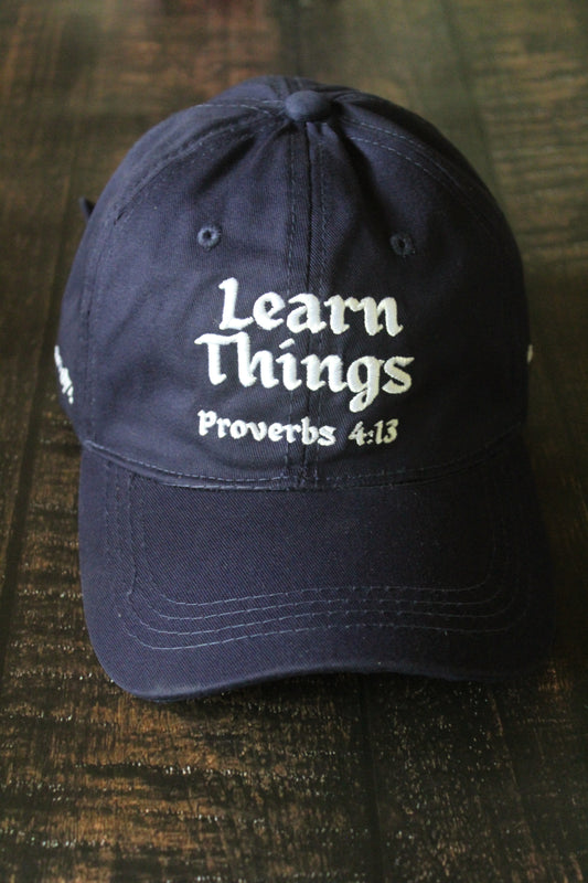 Navy blue embroidered dad cap with Learn Things Proverbs 4:13 design.