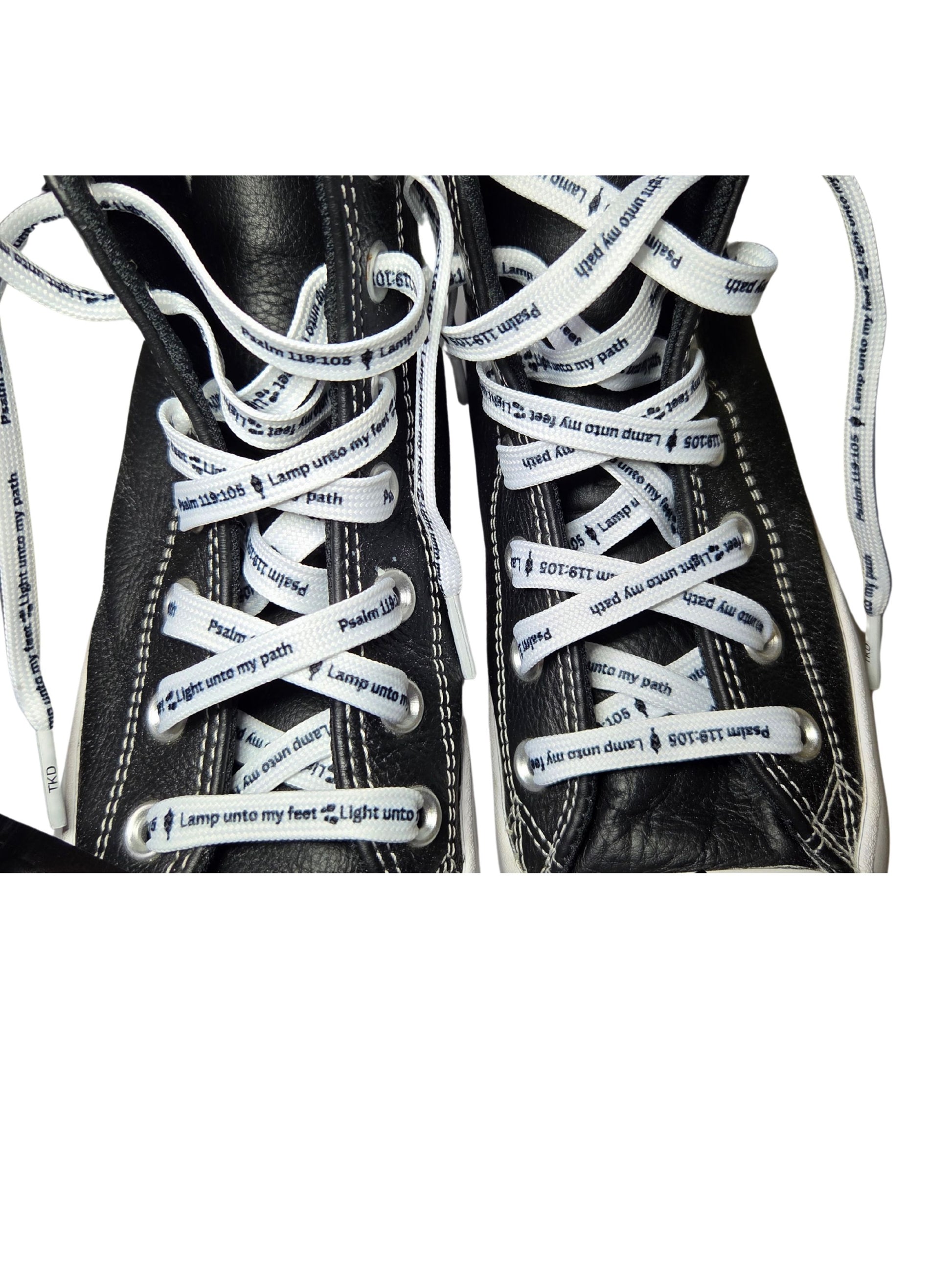 Close-up of Psalm 119:105 verse ‘Lamp unto my feet’ on white Christian shoelaces