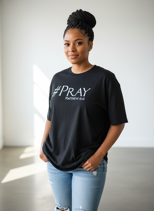 Model wearing black #Pray t-shirt
